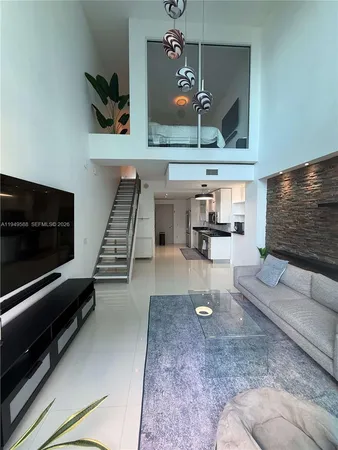 a living room with couches and a flat screen tv