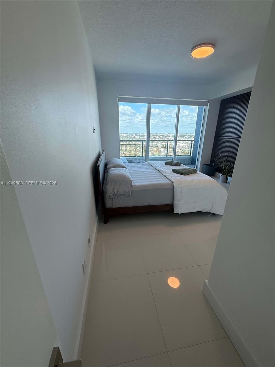 60 Southwest 13th Street, Unit 3808 Miami, FL 33130 - Photo 31 of 38 a living room with furniture and a window