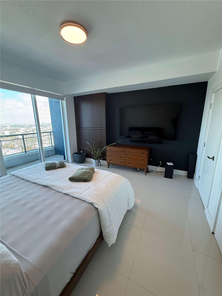 60 Southwest 13th Street, Unit 3808 Miami, FL 33130 - Photo 33 of 38 a bedroom with bed and window
