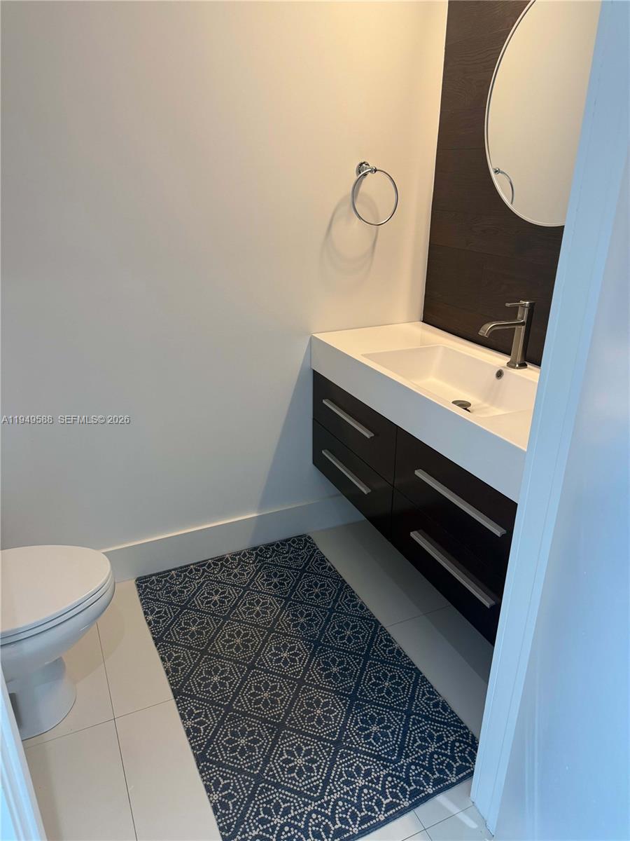 60 Southwest 13th Street, Unit 3808 Miami, FL 33130 - Photo 9 of 38 a bathroom with a sink and a vanity