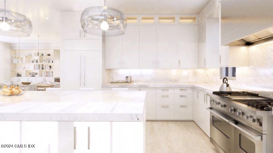 57 Locust Street, Unit A Greenwich, CT 06830 - Photo 14 of 24 a kitchen with granite countertop a sink a stove and cabinets