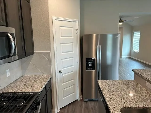 a kitchen with stainless steel appliances granite countertop refrigerator and stove