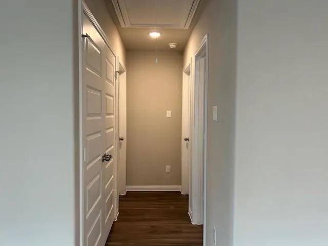 a view of hallway with wooden floor