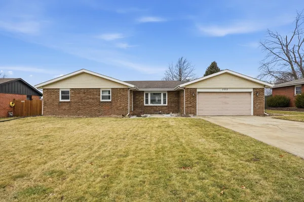 a view of a house with a yard and garage