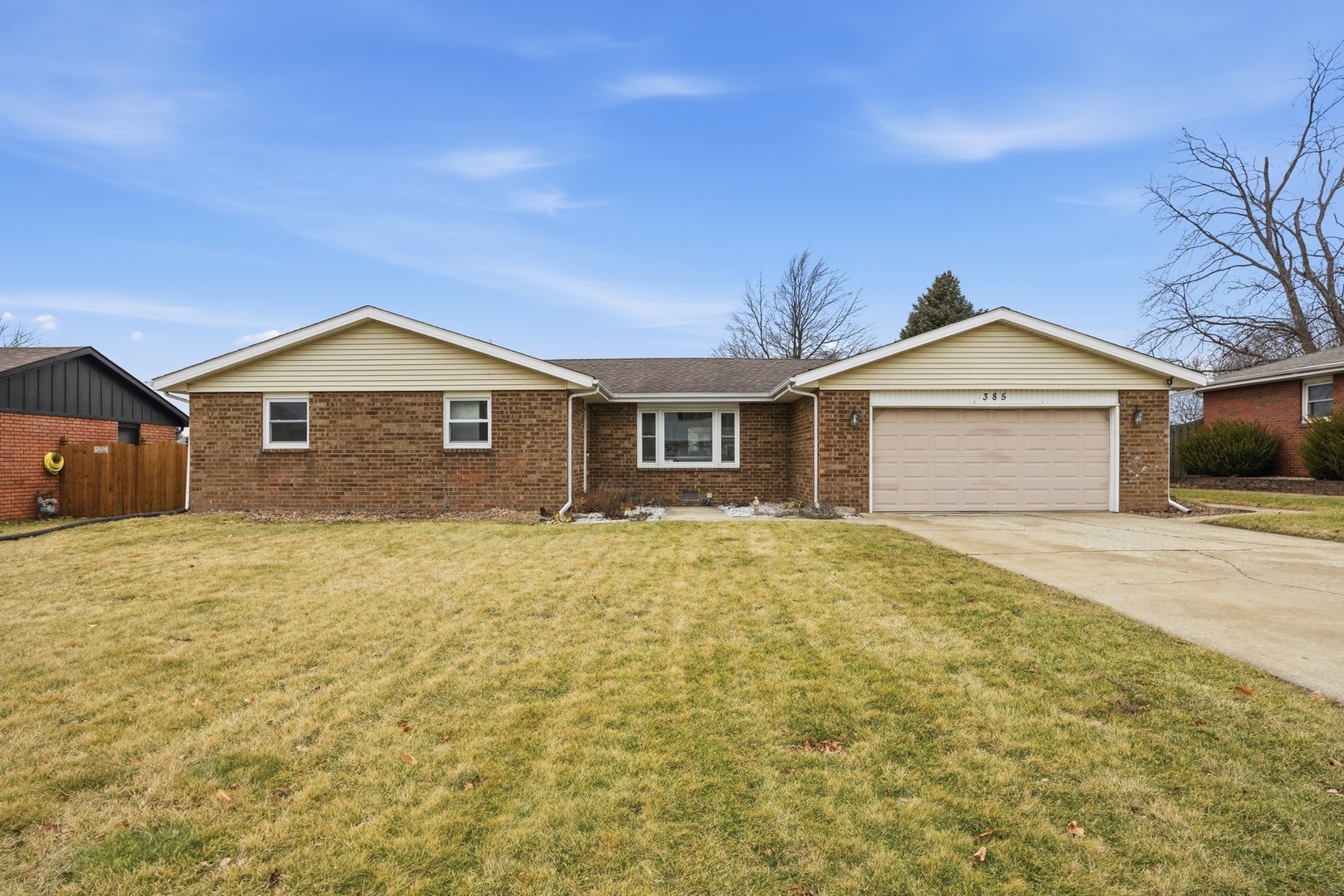 a view of a house with a yard and garage