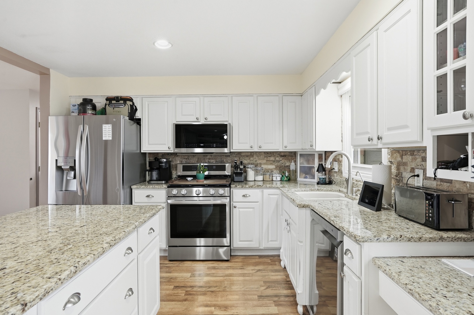385 South Walnut Street Manteno, IL 60950 - Photo 4 of 27 a kitchen with stainless steel appliances granite countertop a sink stove microwave and refrigerator