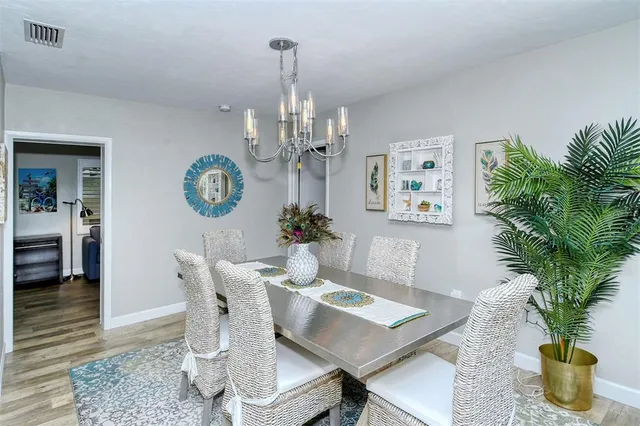 a view of a dining room with furniture and chandelier