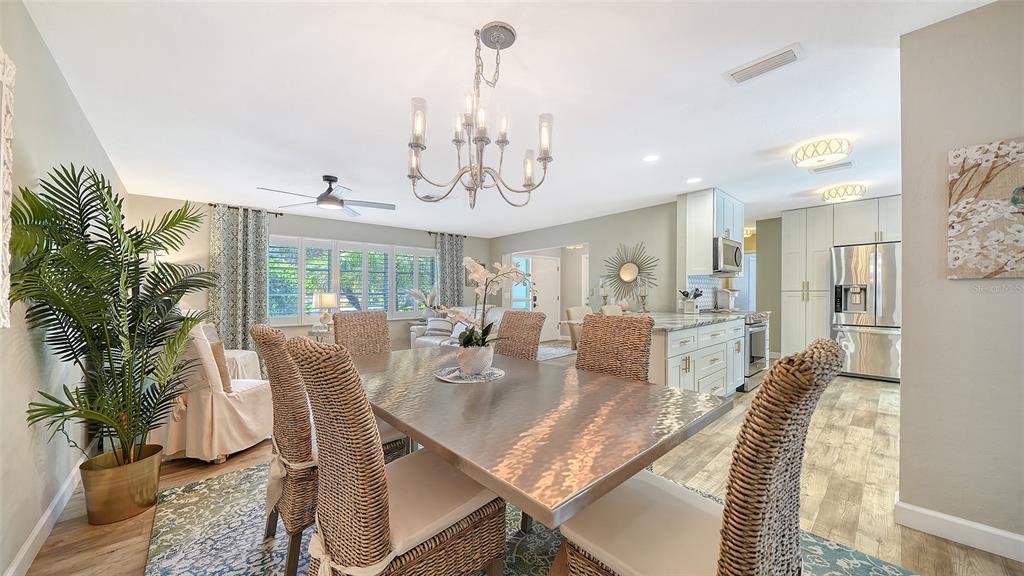 6758 South Lockwood Ridge Road Sarasota, FL 34231 - Photo 14 of 85 a view of a dining room with furniture wooden floor and chandelier