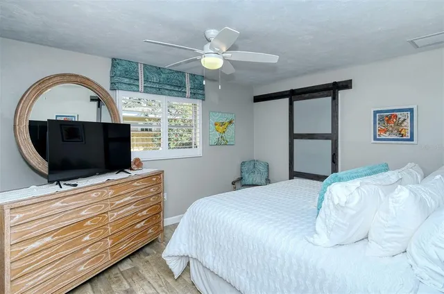 a bathroom with a granite countertop sink a toilet a shower and a mirror