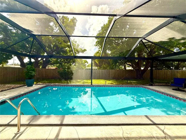 a front view of a house with a yard and potted plants