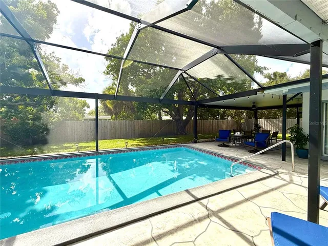a view of outdoor space with swimming pool and seating