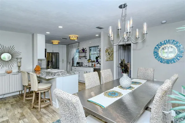 a living room with lots of furniture and kitchen view