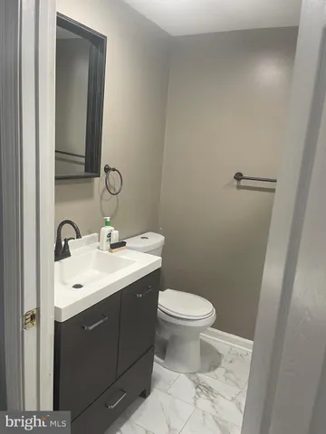 a bathroom with a sink toilet and mirror