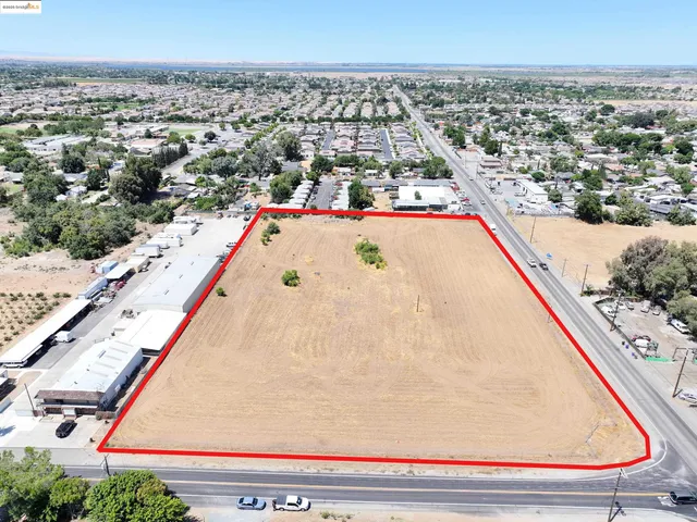 an aerial view of residential houses with yard