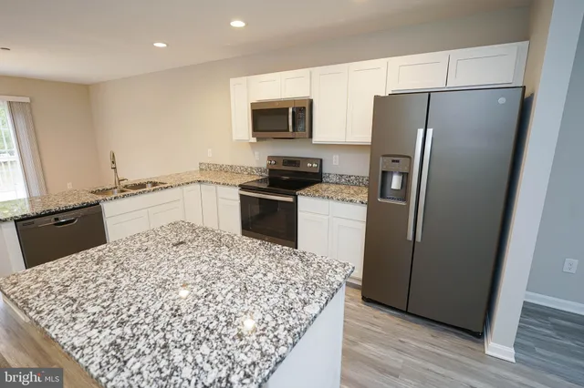 a kitchen with a refrigerator and a sink