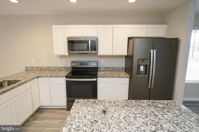 a kitchen with a refrigerator stove and microwave