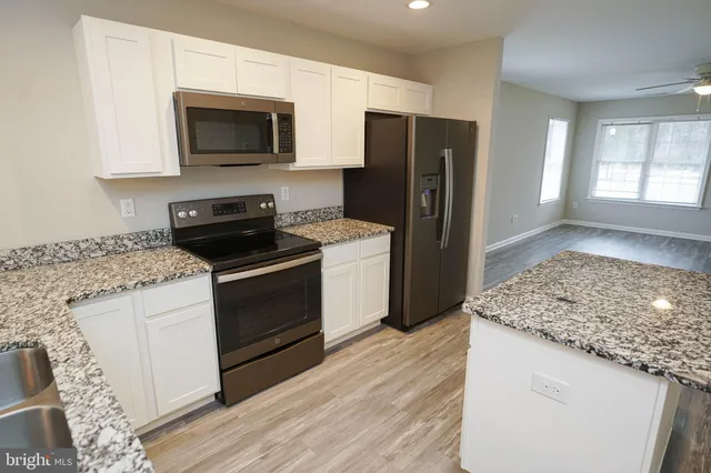 a kitchen with a sink stove and refrigerator