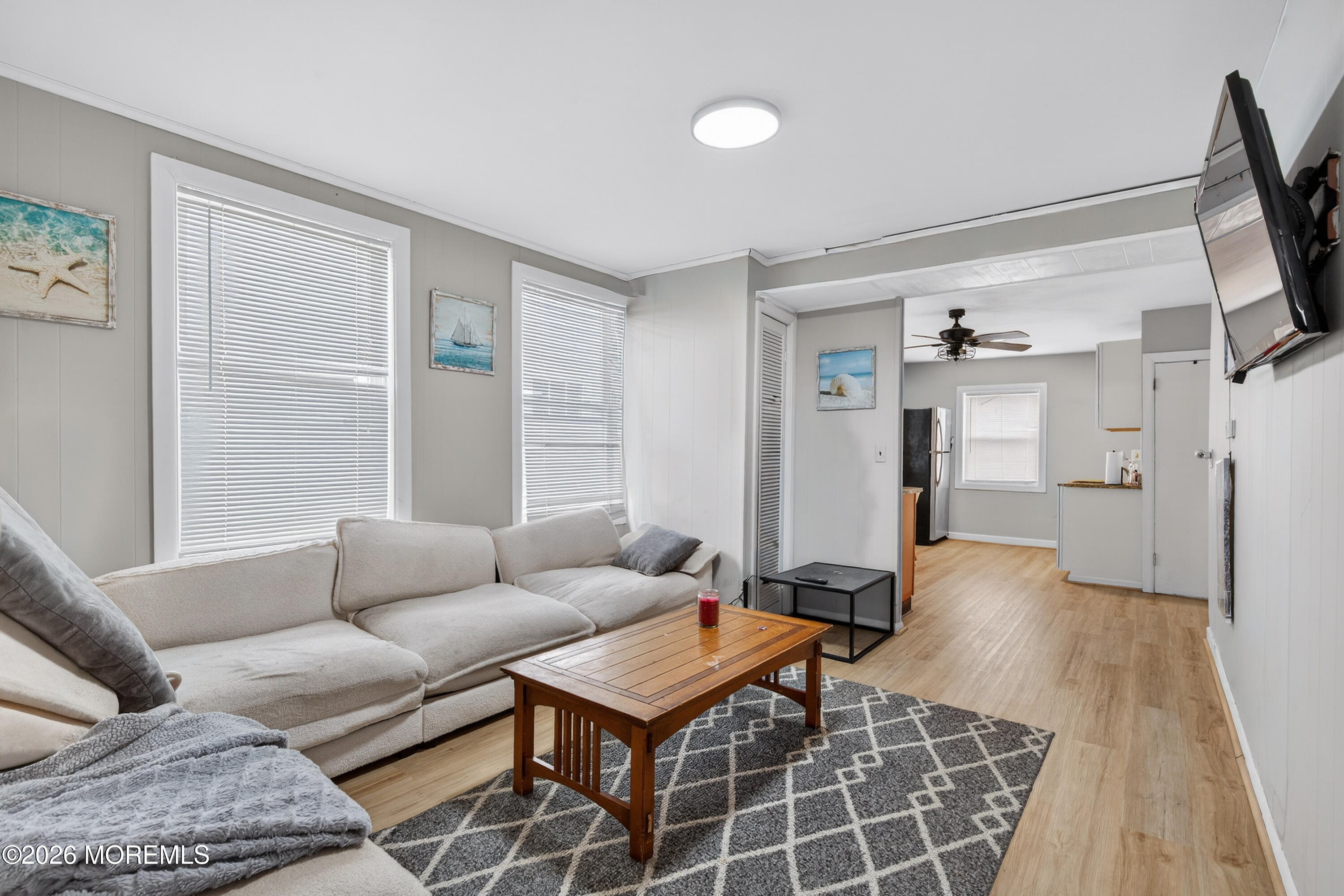 191 3rd Avenue, Unit 2 Manasquan, NJ 08736 - Photo 3 of 10 a living room with furniture and a flat screen tv