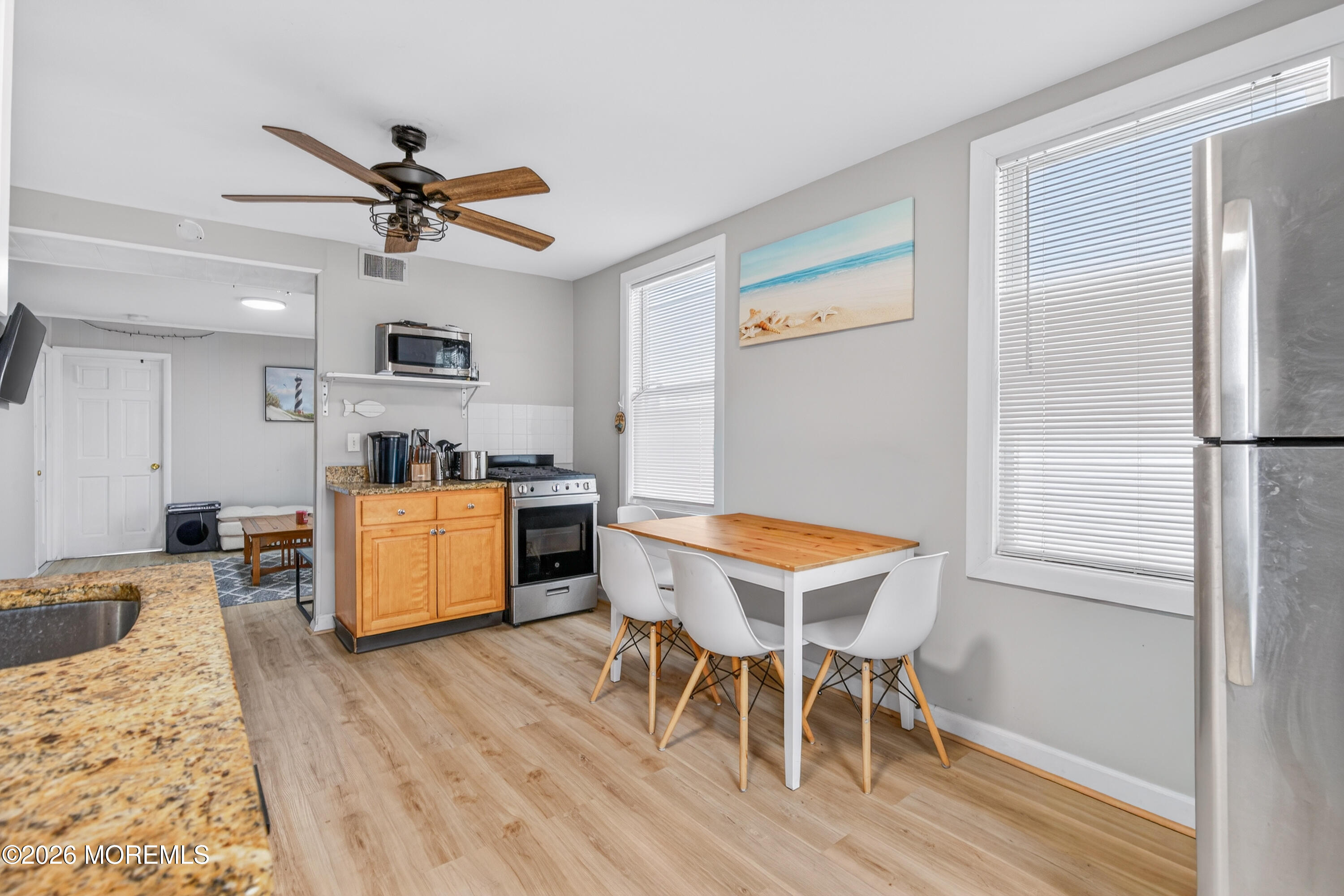 191 3rd Avenue, Unit 2 Manasquan, NJ 08736 - Photo 5 of 10 a view of a dining room with furniture and wooden floor
