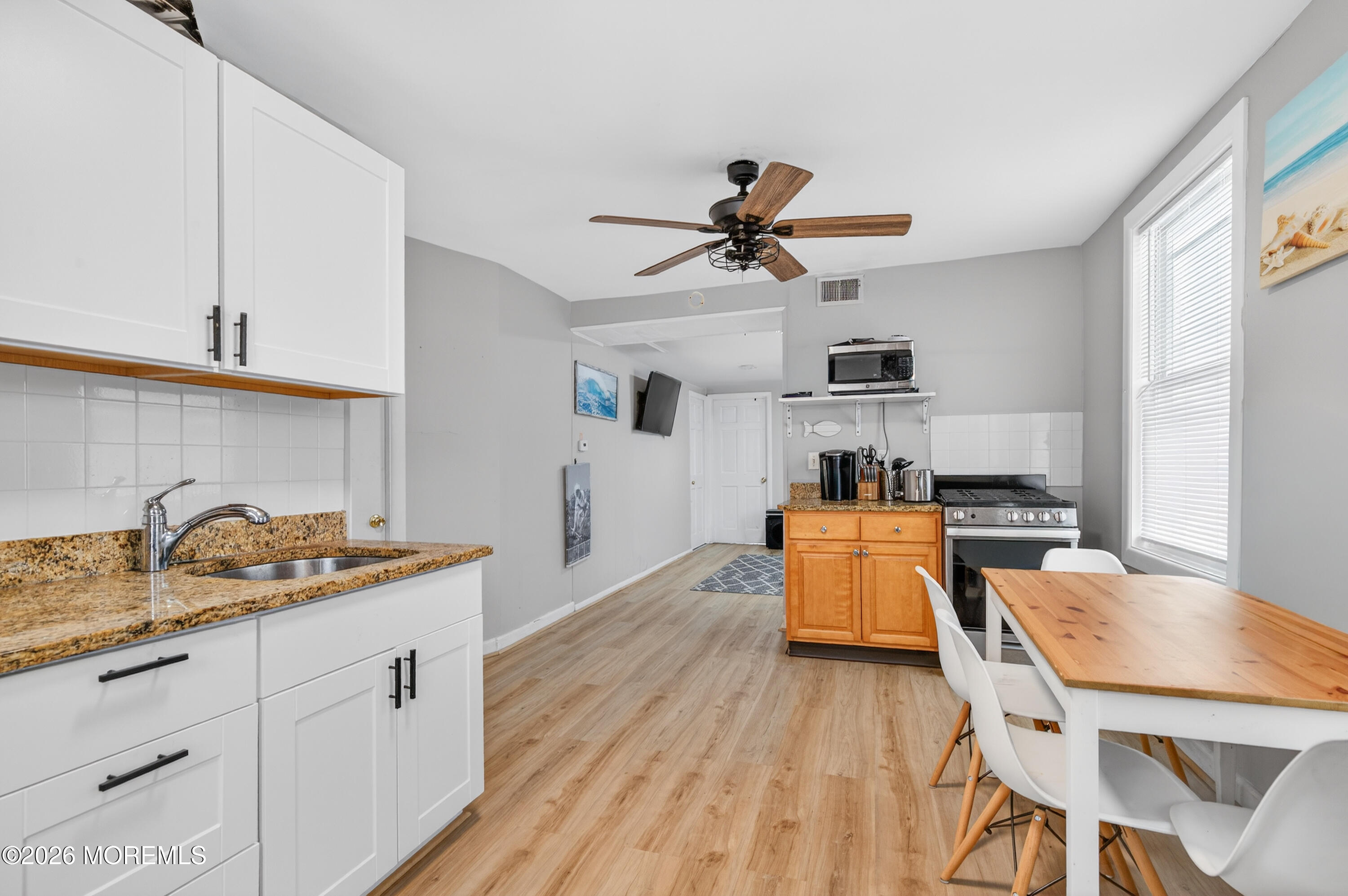 191 3rd Avenue, Unit 2 Manasquan, NJ 08736 - Photo 6 of 10 a kitchen with a table and chairs in it