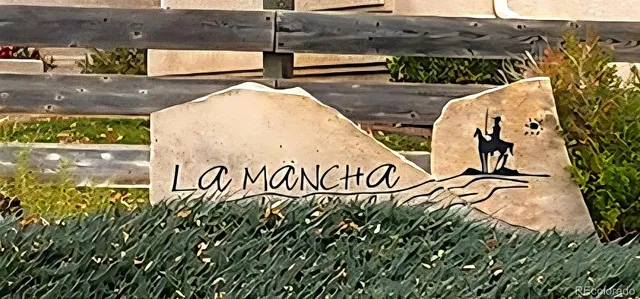 a street sign on a wall next to a road