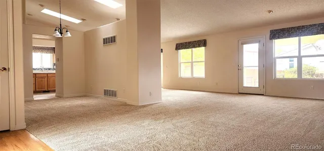 an empty room with windows and entrance