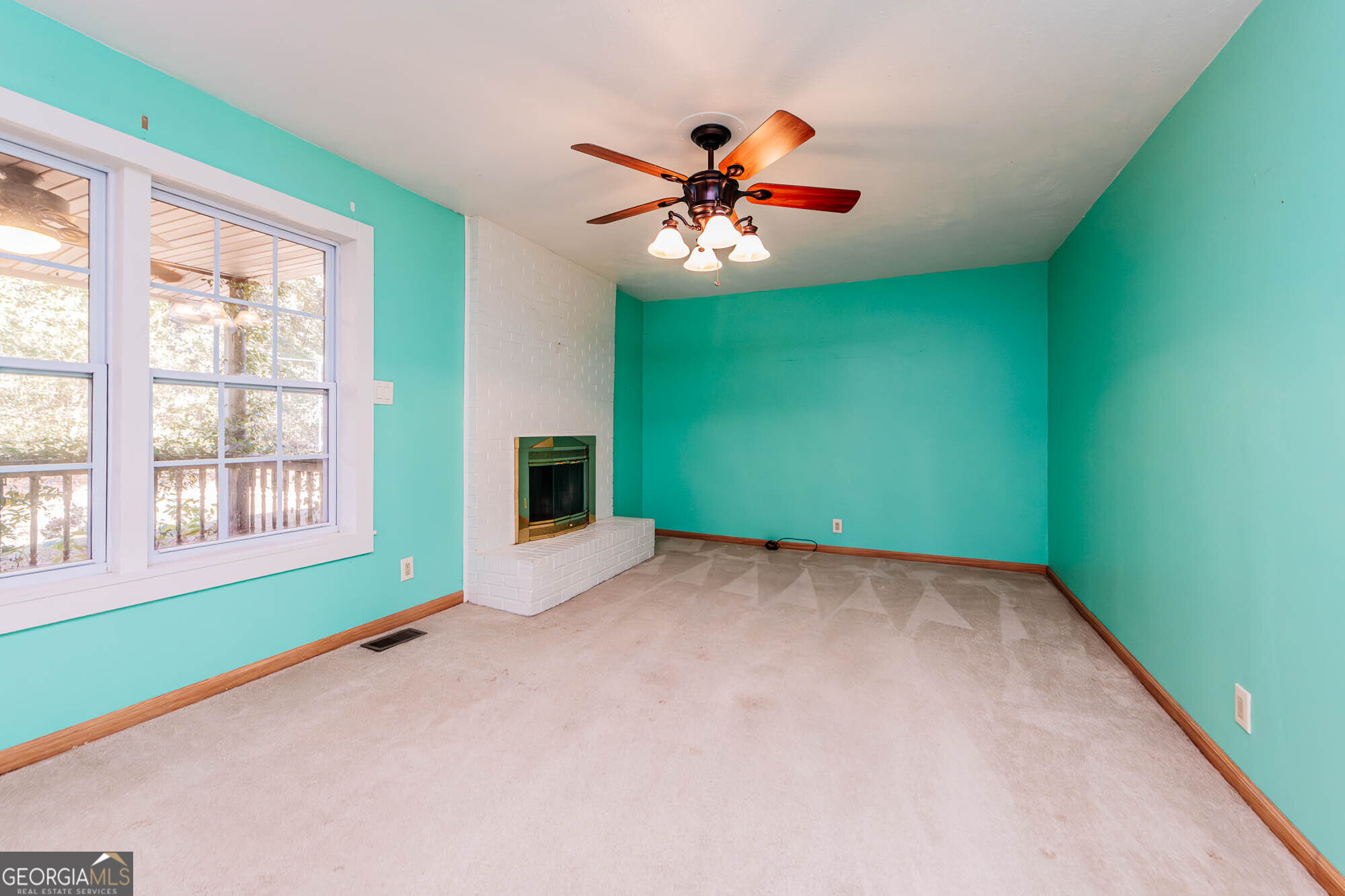 202 Brantley Road Warner Robins, GA 31093 - Photo 14 of 52 a view of an empty room with a window and a ceiling fan