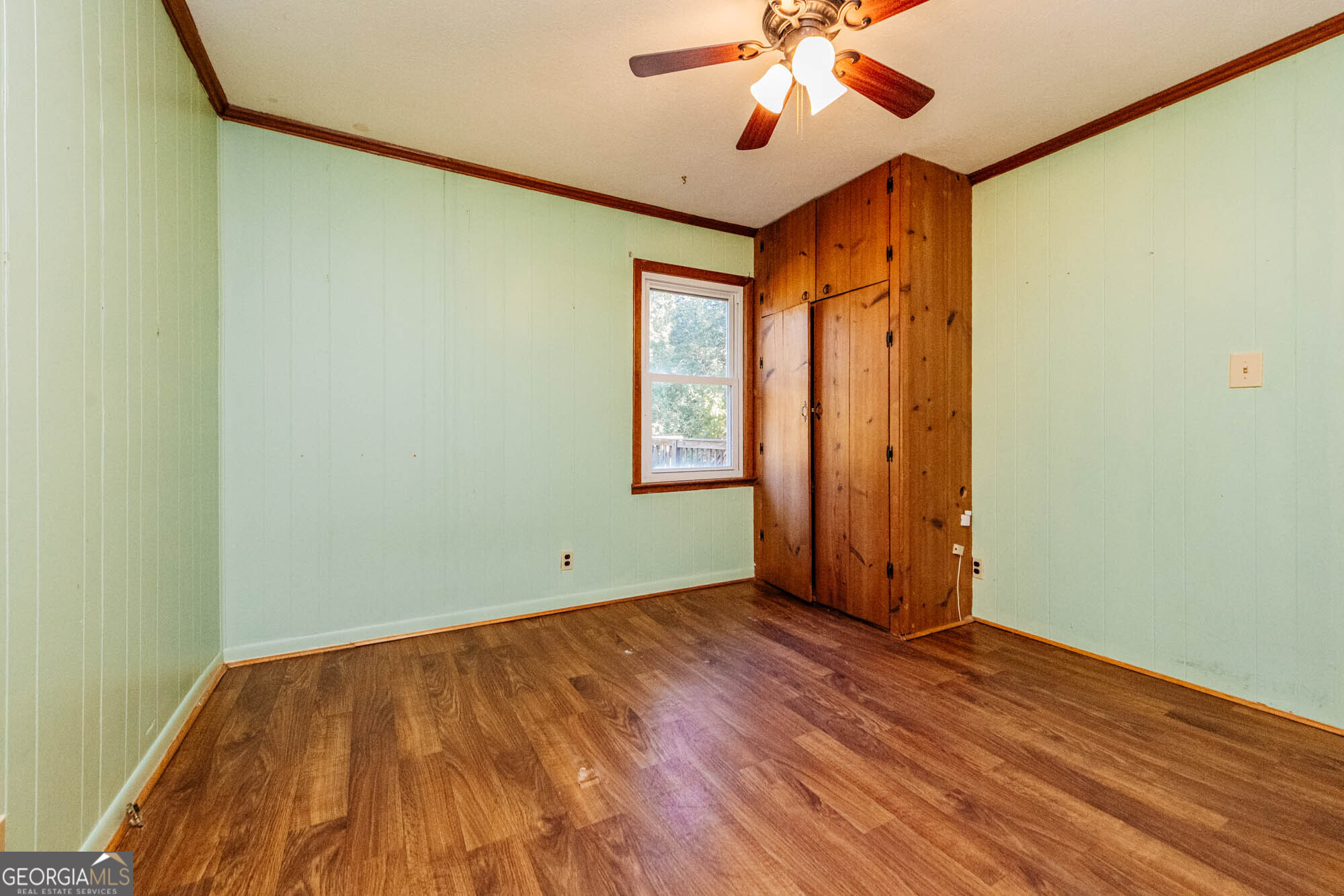 202 Brantley Road Warner Robins, GA 31093 - Photo 24 of 52 an empty room with wooden floor fan and windows