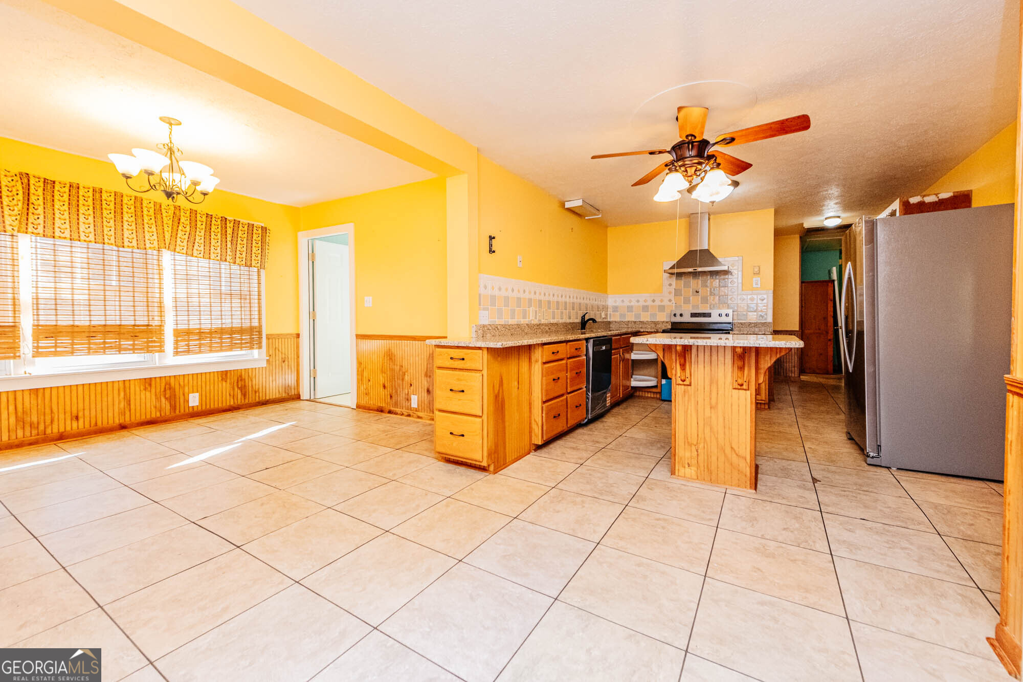 202 Brantley Road Warner Robins, GA 31093 - Photo 33 of 52 a view of a kitchen with stainless steel appliances kitchen island granite countertop a refrigerator a stove top oven and a large window