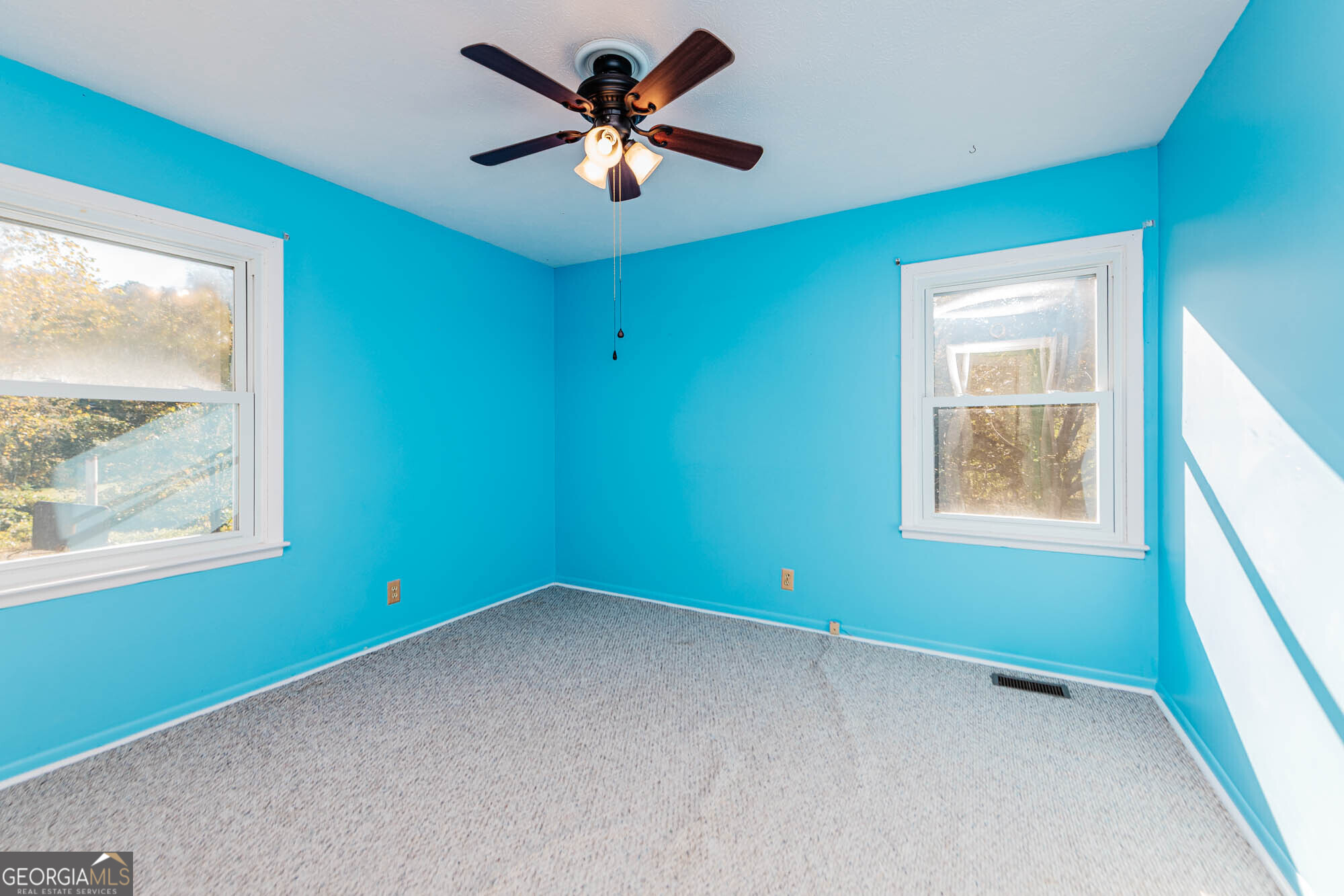 202 Brantley Road Warner Robins, GA 31093 - Photo 6 of 52 an empty room with a window and a fan