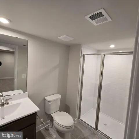 a bathroom with a sink a toilet a mirror and vanity
