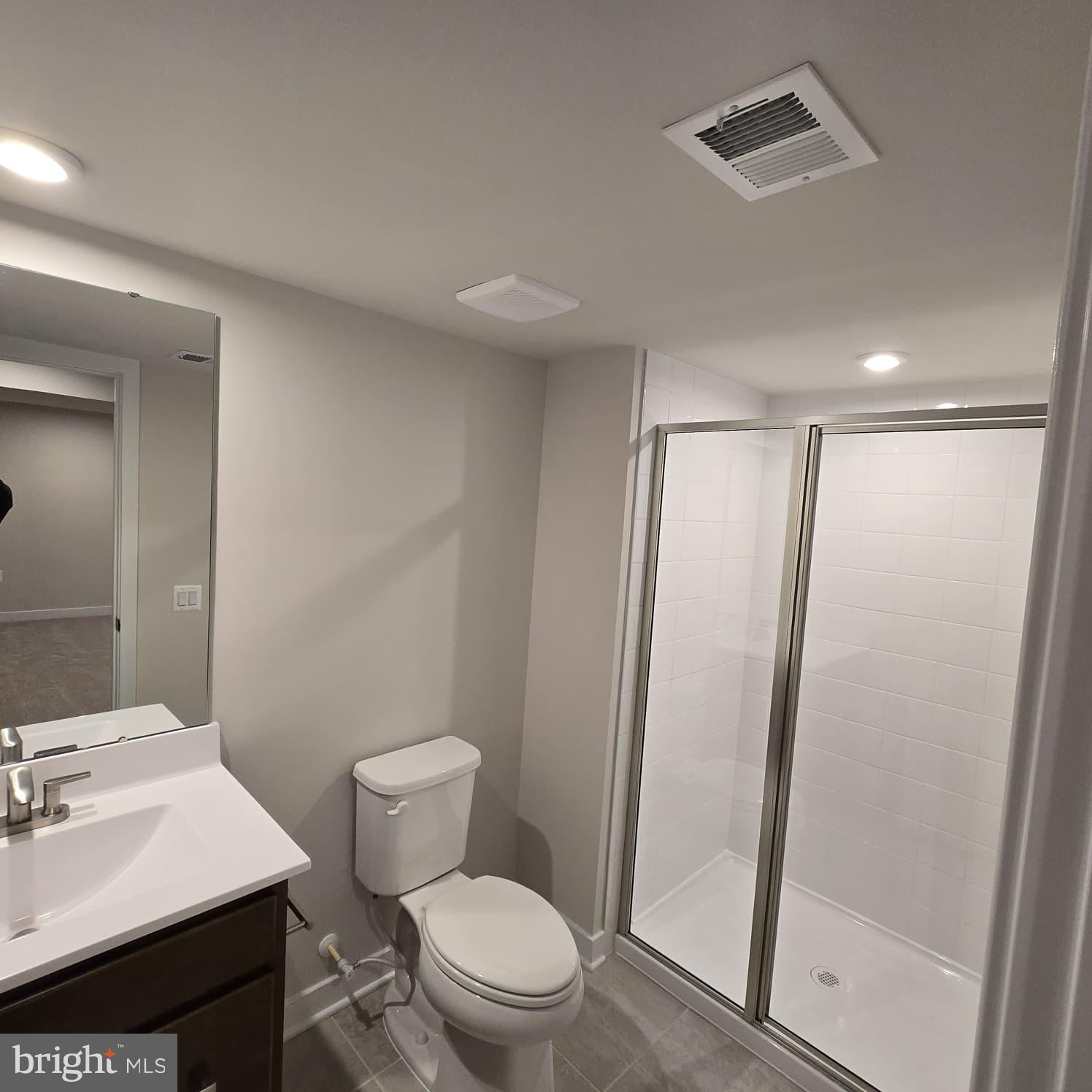 4218 Falkirk Place Fredericksburg, VA 22408 - Photo 12 of 36 a bathroom with a sink a toilet a mirror and vanity
