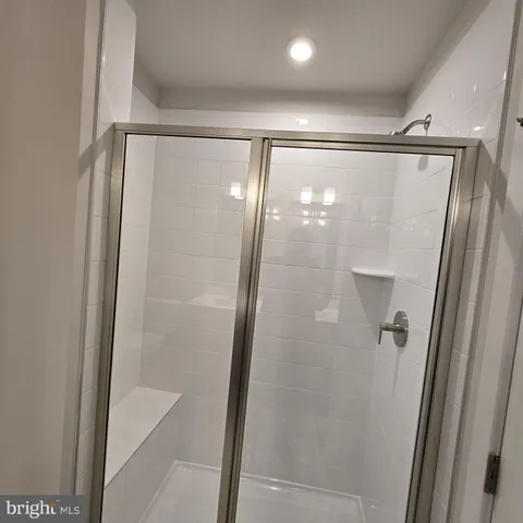 a bathroom with a glass door shower and a glass door