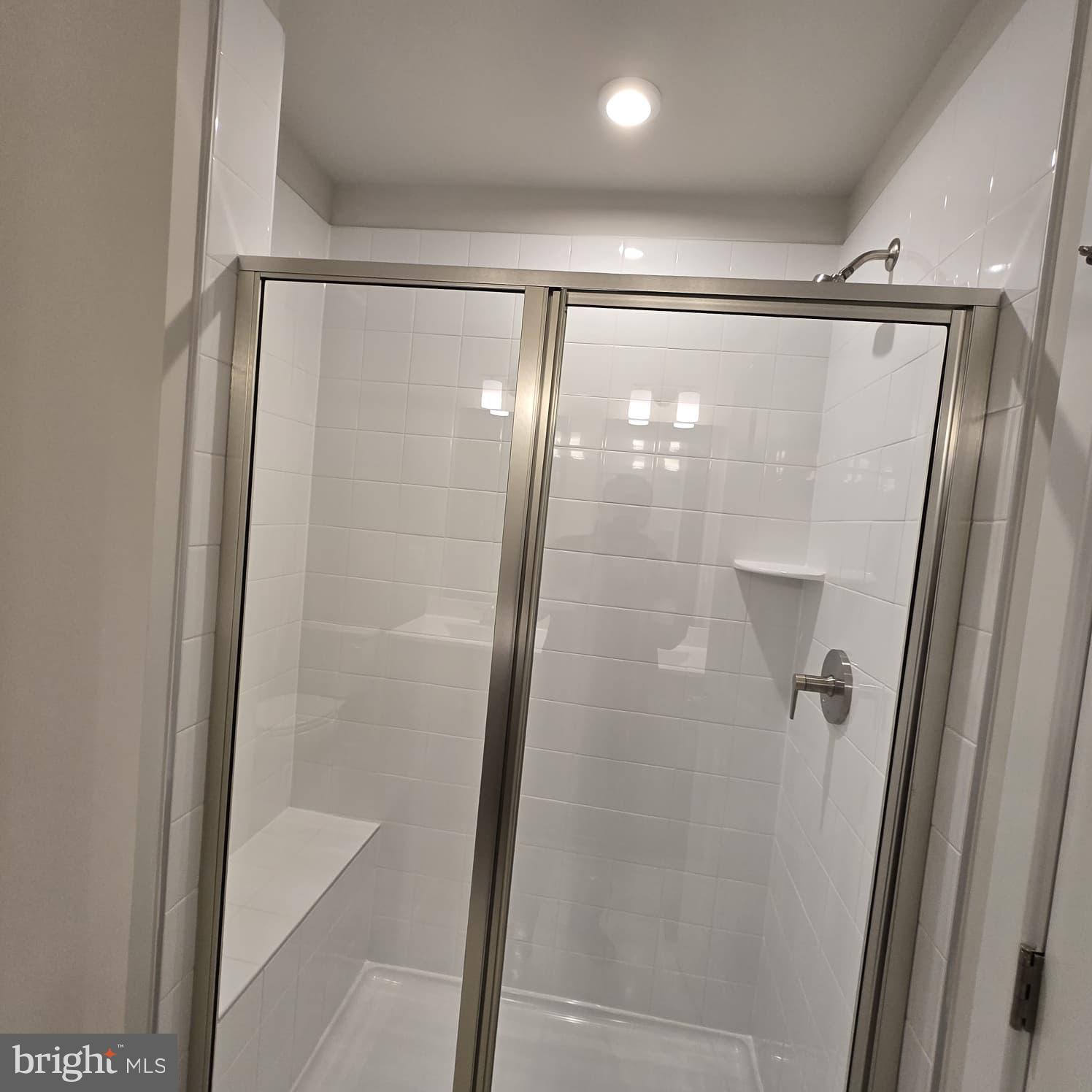 4218 Falkirk Place Fredericksburg, VA 22408 - Photo 15 of 36 a bathroom with a glass door shower and a glass door