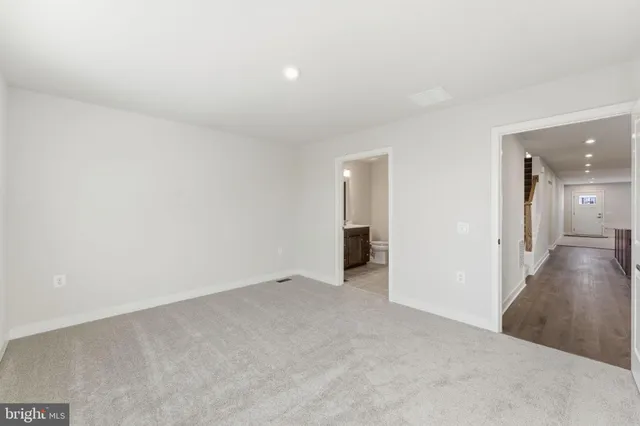 a bathroom with a double vanity sink toilet and mirror