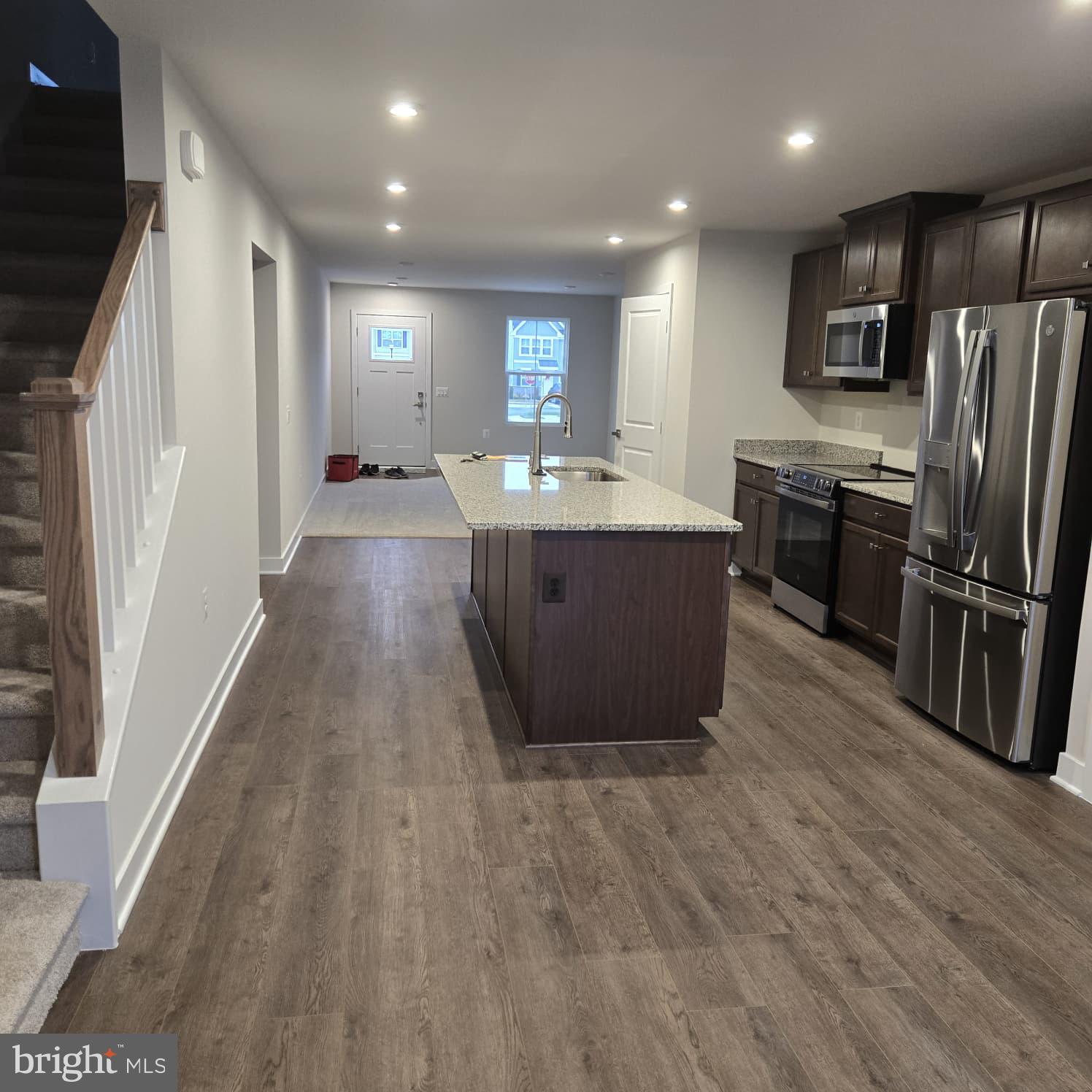 4218 Falkirk Place Fredericksburg, VA 22408 - Photo 24 of 36 a large kitchen with stainless steel appliances wooden floors and wooden cabinets