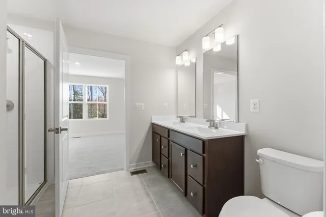 a view of a hallway with closet and bathroom