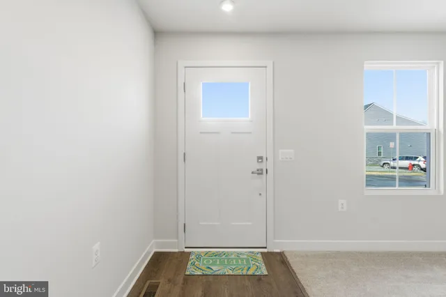 a view of hallway with sink and a window