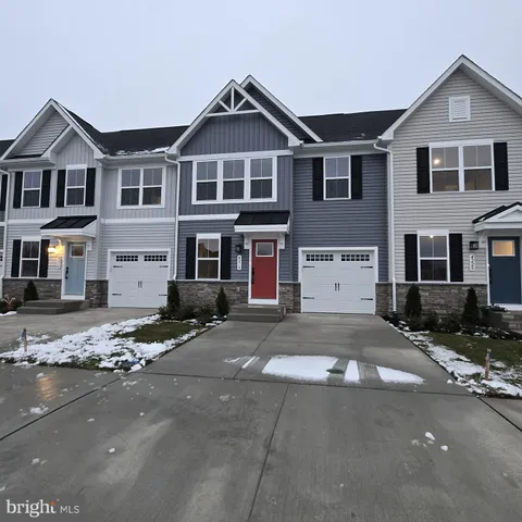 a front view of a house with a road