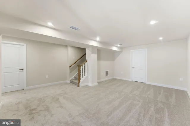 a bathroom with a sink a toilet a mirror and shower