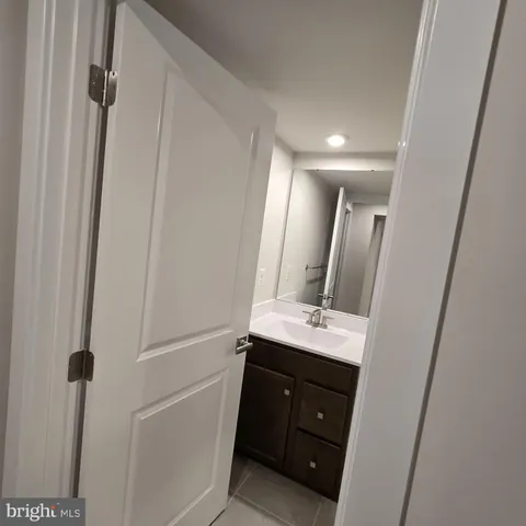 a bathroom with a sink a mirror a vanity and a shower