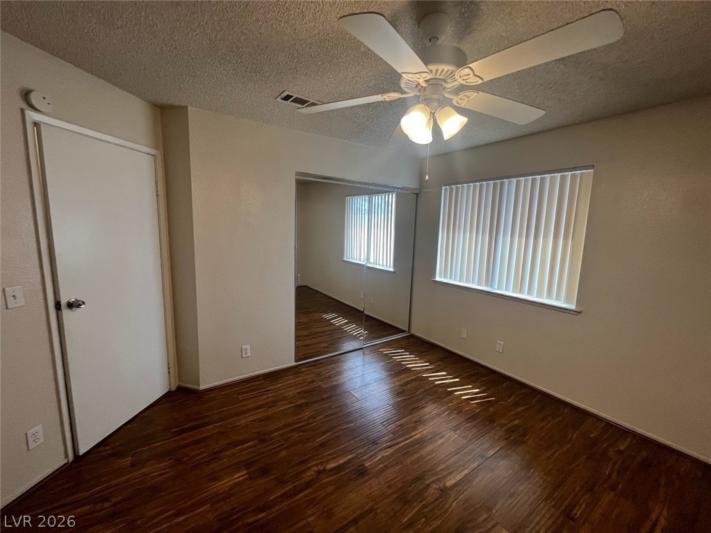 914 Scarlet Ridge Drive Las Vegas, NV 89128 - Photo 24 of 25 Rich hardwood-style flooring extends across this naturally illuminated bedroom with a ceiling fan.
