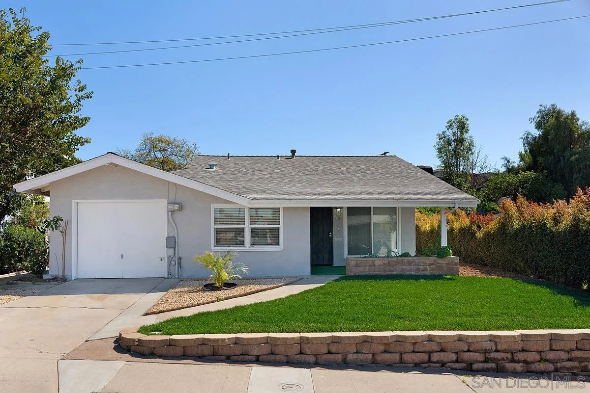 6357 Streamview Drive San Diego, CA 92115 - Photo 1 of 13 a front view of a house with a yard and garage