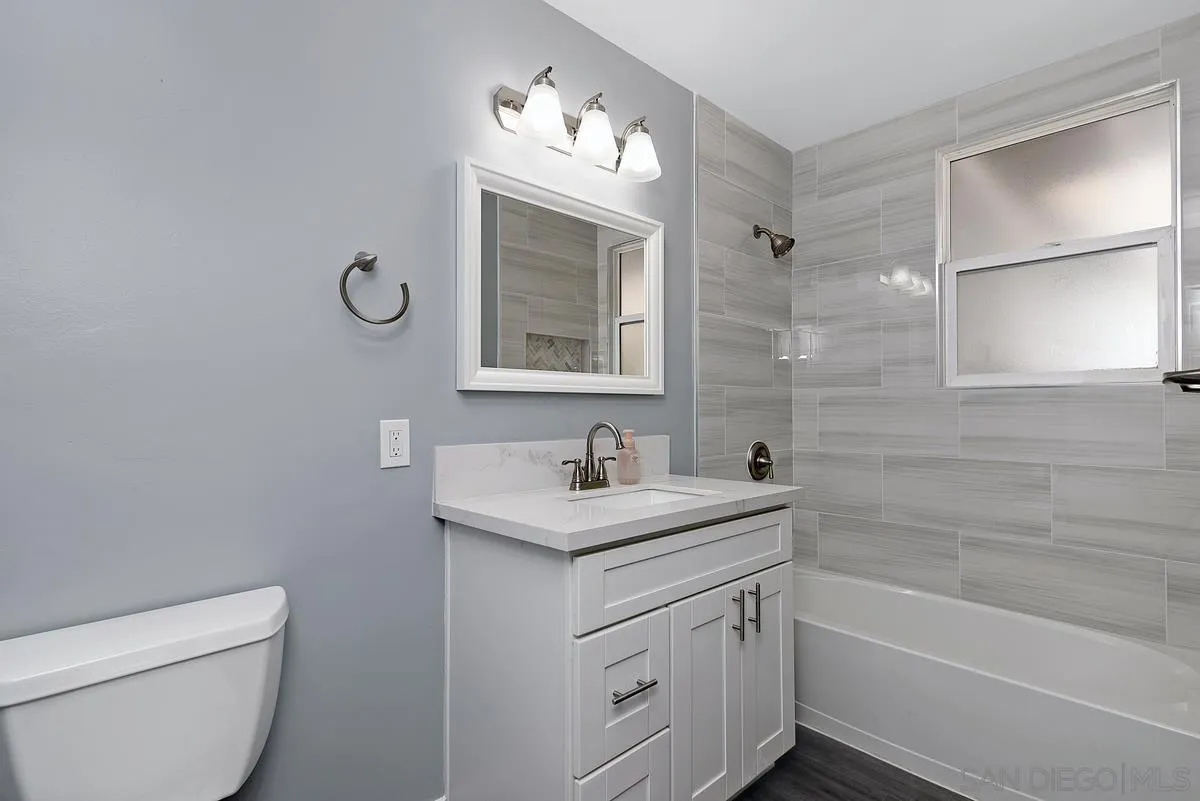 6357 Streamview Drive San Diego, CA 92115 - Photo 8 of 13 a bathroom with a granite countertop sink a toilet and shower