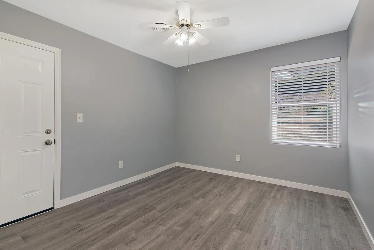 6357 Streamview Drive San Diego, CA 92115 - Photo 9 of 13 wooden floor in an empty room with a window