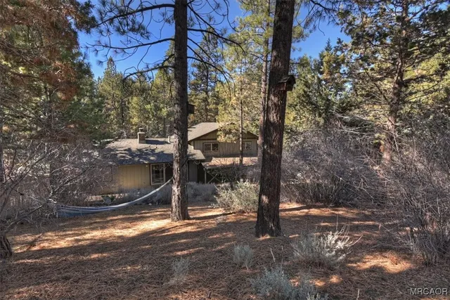 a view of backyard with furniture and wooden deck