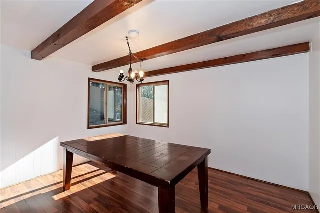 a view of hall way with furniture and wooden floor