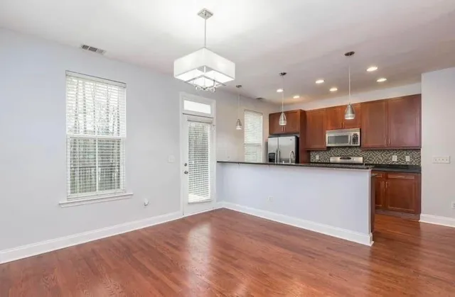 a view of a kitchen with a sink stainless steel appliances and cabinets