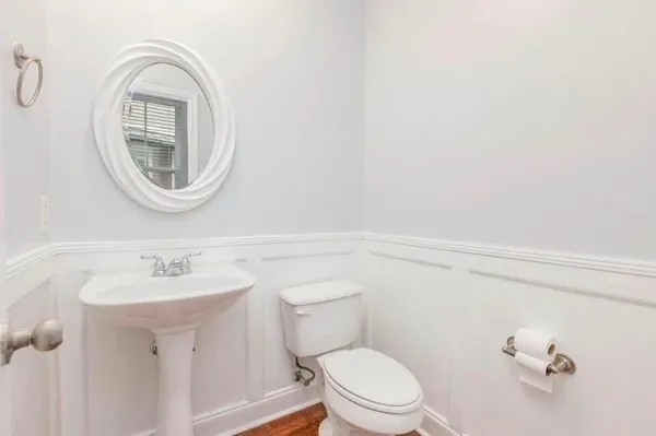 a bathroom with a toilet a sink and a mirror
