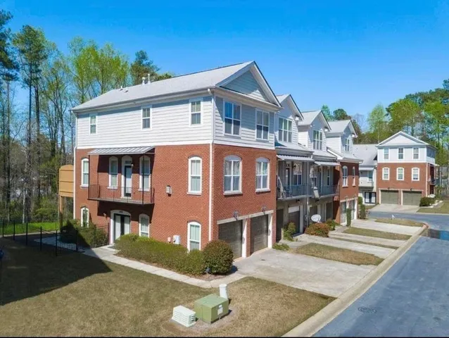 a front view of residential houses with yard